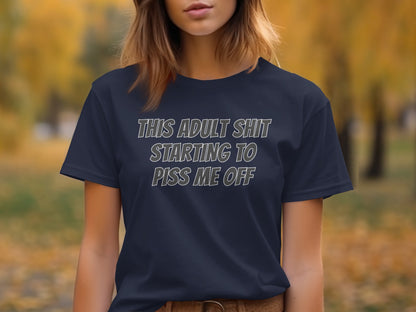 Dark blue t-shirt with white text reading "THIS ADULT SHIT STARTING TO PISS ME OFF."
