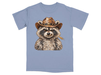 Light blue t-shirt featuring a watercolor raccoon wearing a cowboy hat and holding wheat.