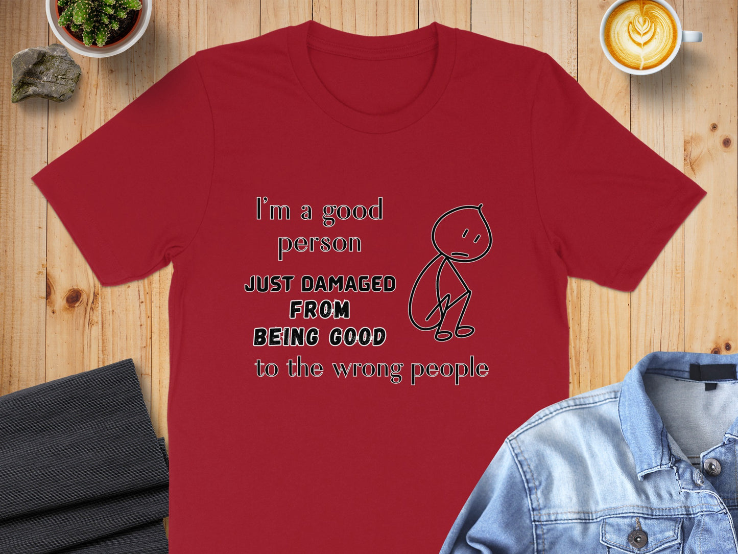 Red t-shirt with text and a stick figure graphic.