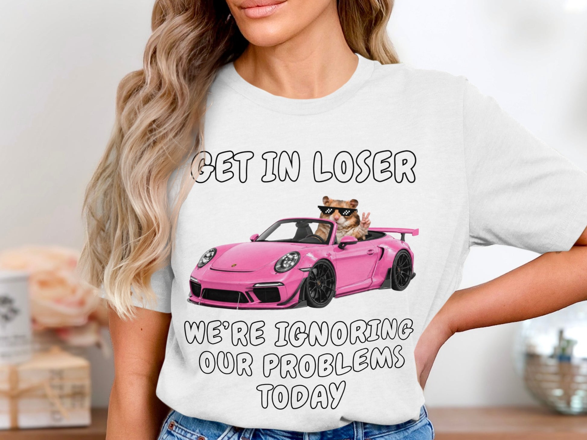 Hamster in pink convertible with sunglasses, text "GET IN LOSER WE'RE IGNORING OUR PROBLEMS TODAY."