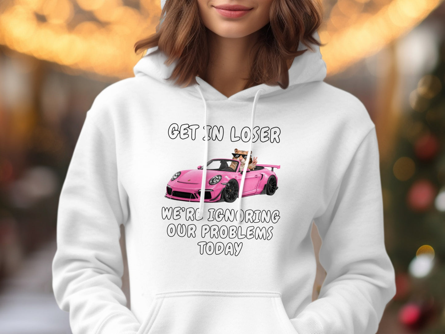 White hoodie with "GET IN LOSER" and a pink car with cats ignoring problems.