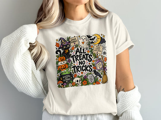 White t-shirt with "All Treats No Tricks" Halloween graphic featuring a black cat, ghost, and pumpkins.