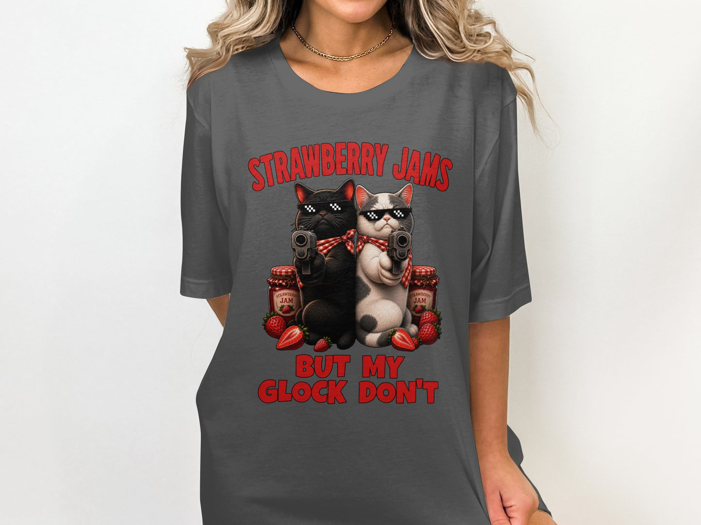 T-shirt graphic: two cats with sunglasses holding guns, strawberry jam, and text.