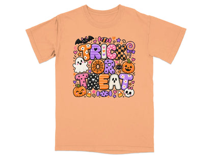 Orange t-shirt with "Trick or Treat" Halloween graphic featuring pumpkins, ghosts, and candy.