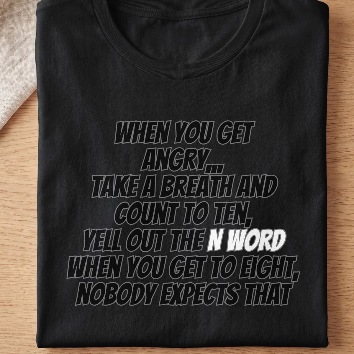 Black t-shirt with text: "When you get angry, take a breath and count to ten, yell out the N-word when you get to eight, nobody expects that."