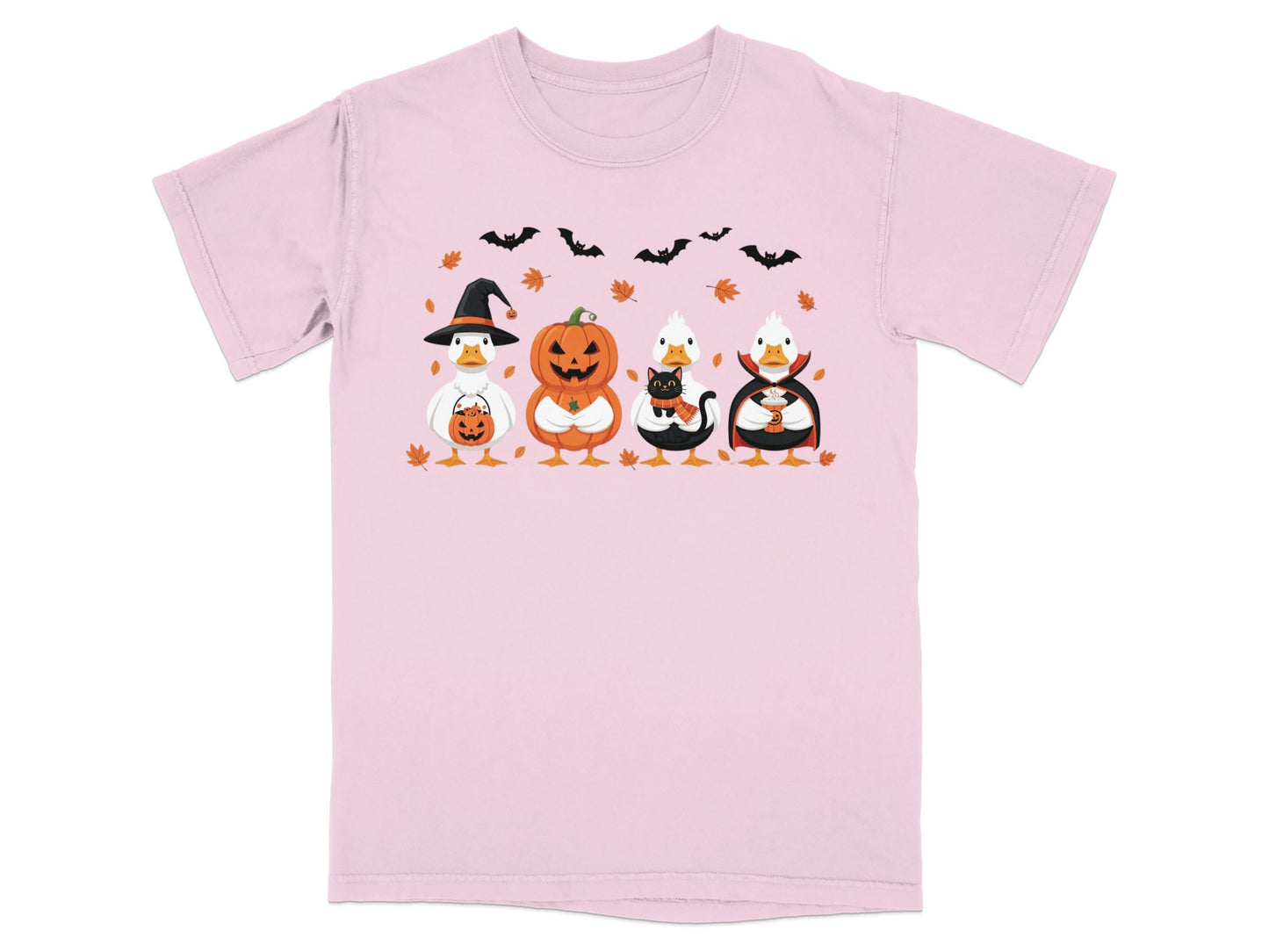 Pink t-shirt with four festive ducks in Halloween costumes and falling leaves.