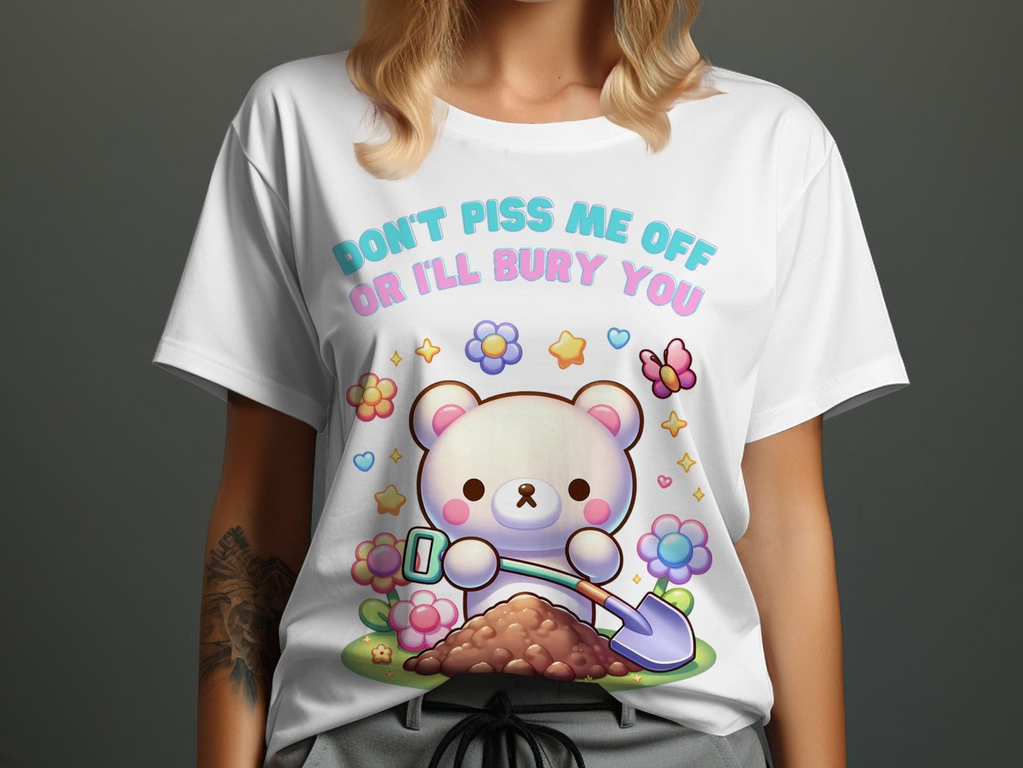 White t-shirt with cartoon bear digging with a shovel and flowers, text reads "Don't piss me off or I'll bury you".