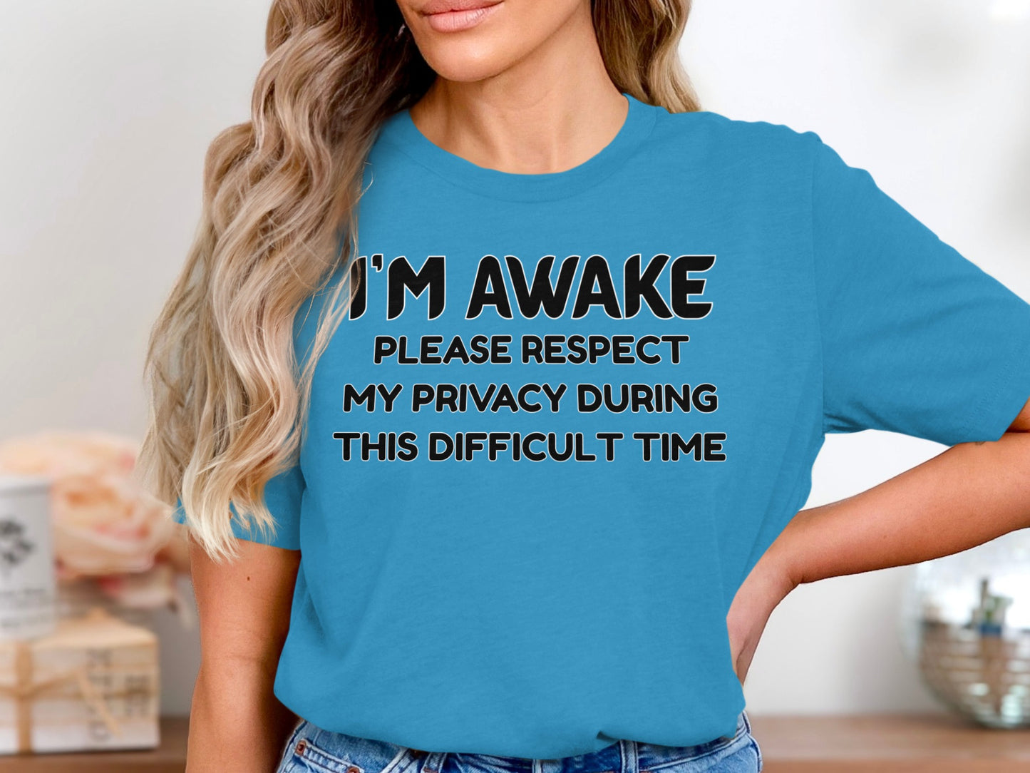 Blue t-shirt with black text saying "I'M AWAKE PLEASE RESPECT MY PRIVACY DURING THIS DIFFICULT TIME".