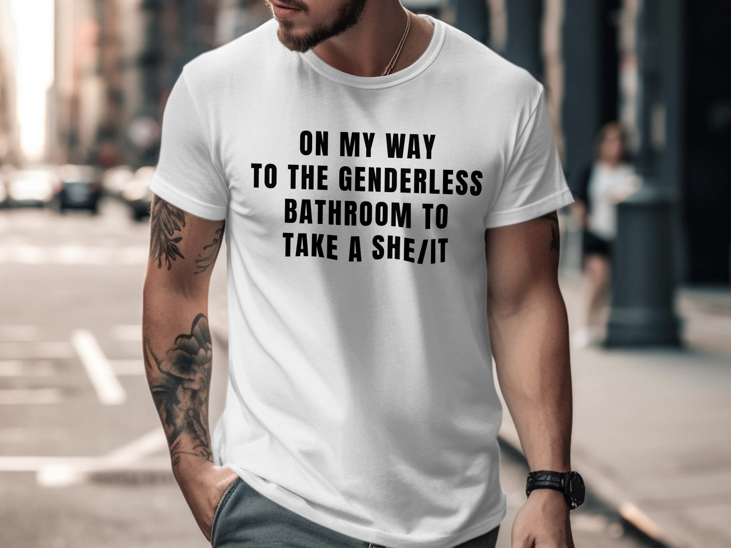 White t-shirt with black text reading "ON MY WAY TO THE GENDERLESS BATHROOM TO TAKE A SHE/IT".