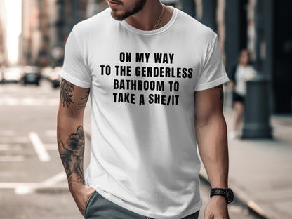 White t-shirt with black text reading "ON MY WAY TO THE GENDERLESS BATHROOM TO TAKE A SHE/IT".