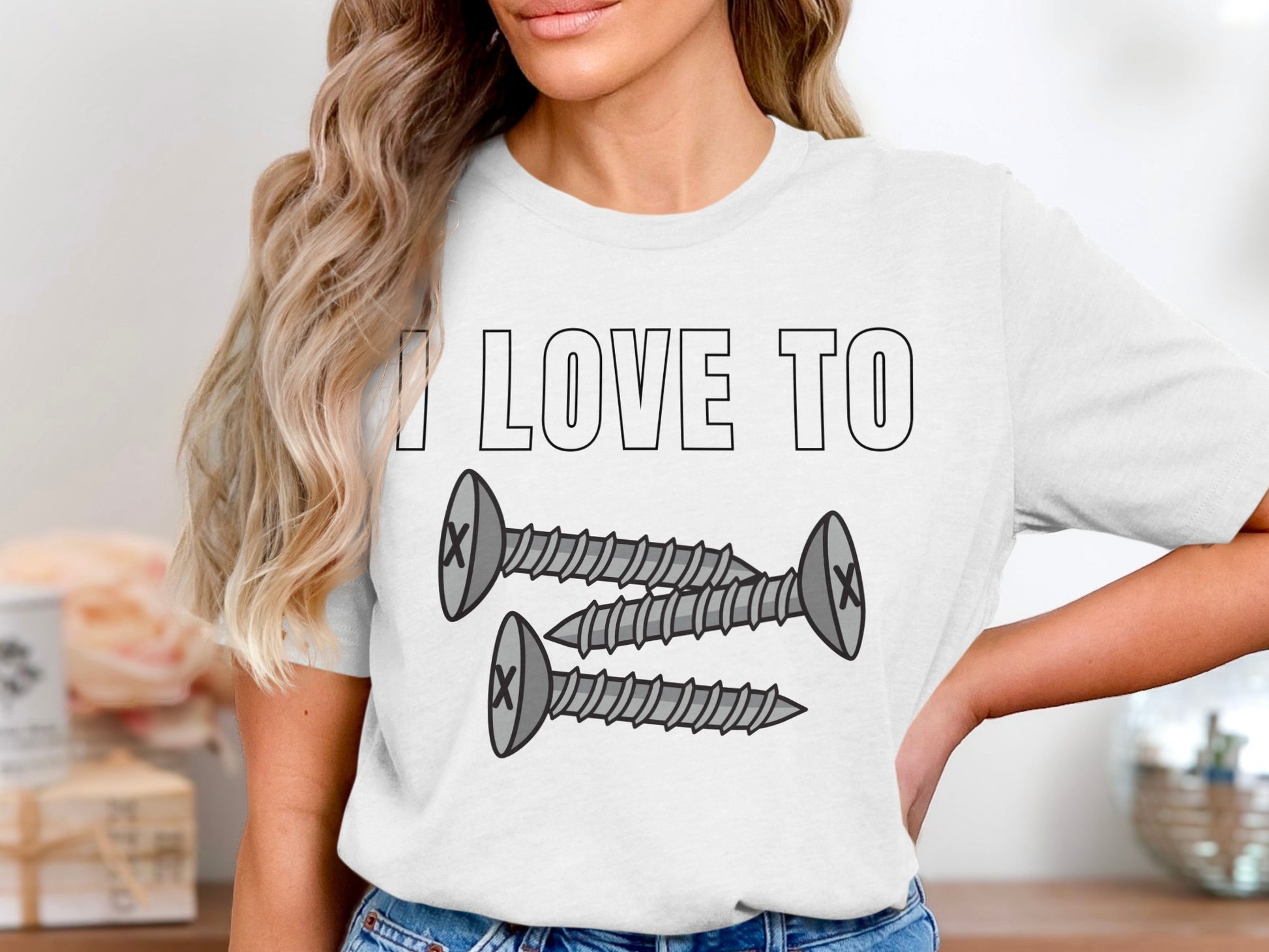 White t-shirt with "I LOVE TO" and three cartoon screws.