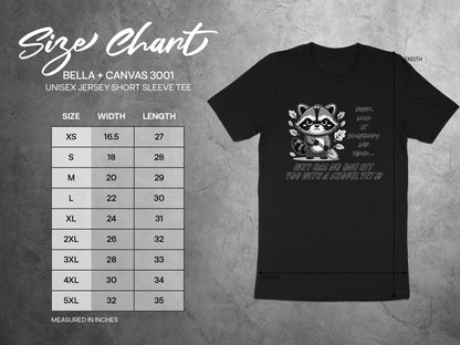Bella + Canvas 3001 size chart with shirt graphic featuring distressed raccoon holding shovel.