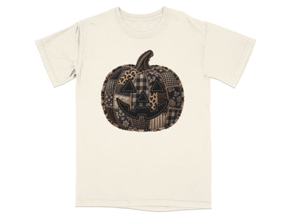 Cream t-shirt with a patchwork Halloween pumpkin graphic.