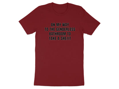 Maroon t-shirt with text "ON MY WAY TO THE GENDERLESS BATHROOM TO TAKE A SHE/IT".
