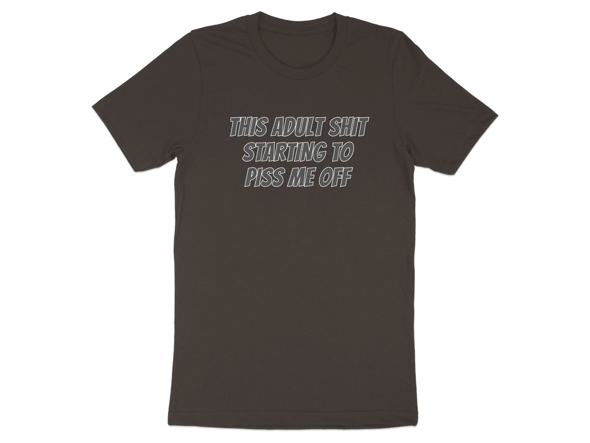 Dark brown t-shirt with white text "THIS ADULT SHIT STARTING TO PISS ME OFF".