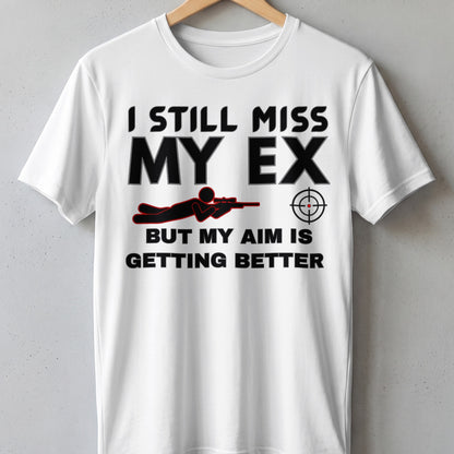 White t-shirt with "I still miss my ex but my aim is getting better" text and graphic.