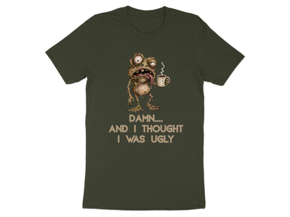 Green t-shirt with illustration of a grotesque frog holding coffee and text "Damn.... And I Thought I Was Ugly".