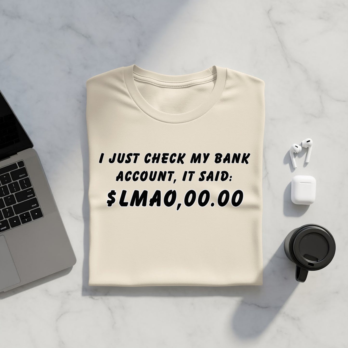 Cream t-shirt with humorous text: "I JUST CHECK MY BANK ACCOUNT, IT SAID: $LMAO,00.00"