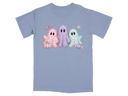 Three patchwork Halloween ghosts on a periwinkle t-shirt.