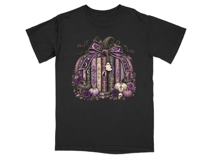Black t-shirt with a Halloween-themed pumpkin design featuring books, pumpkins, flowers, and bats.