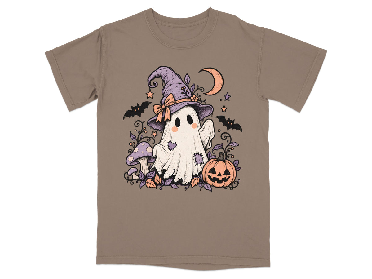 Ghost with witch hat, pumpkin, mushrooms, bats, and crescent moon on brown t-shirt.