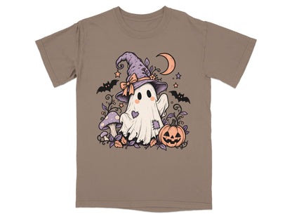Ghost with witch hat, pumpkin, mushrooms, bats, and crescent moon on brown t-shirt.