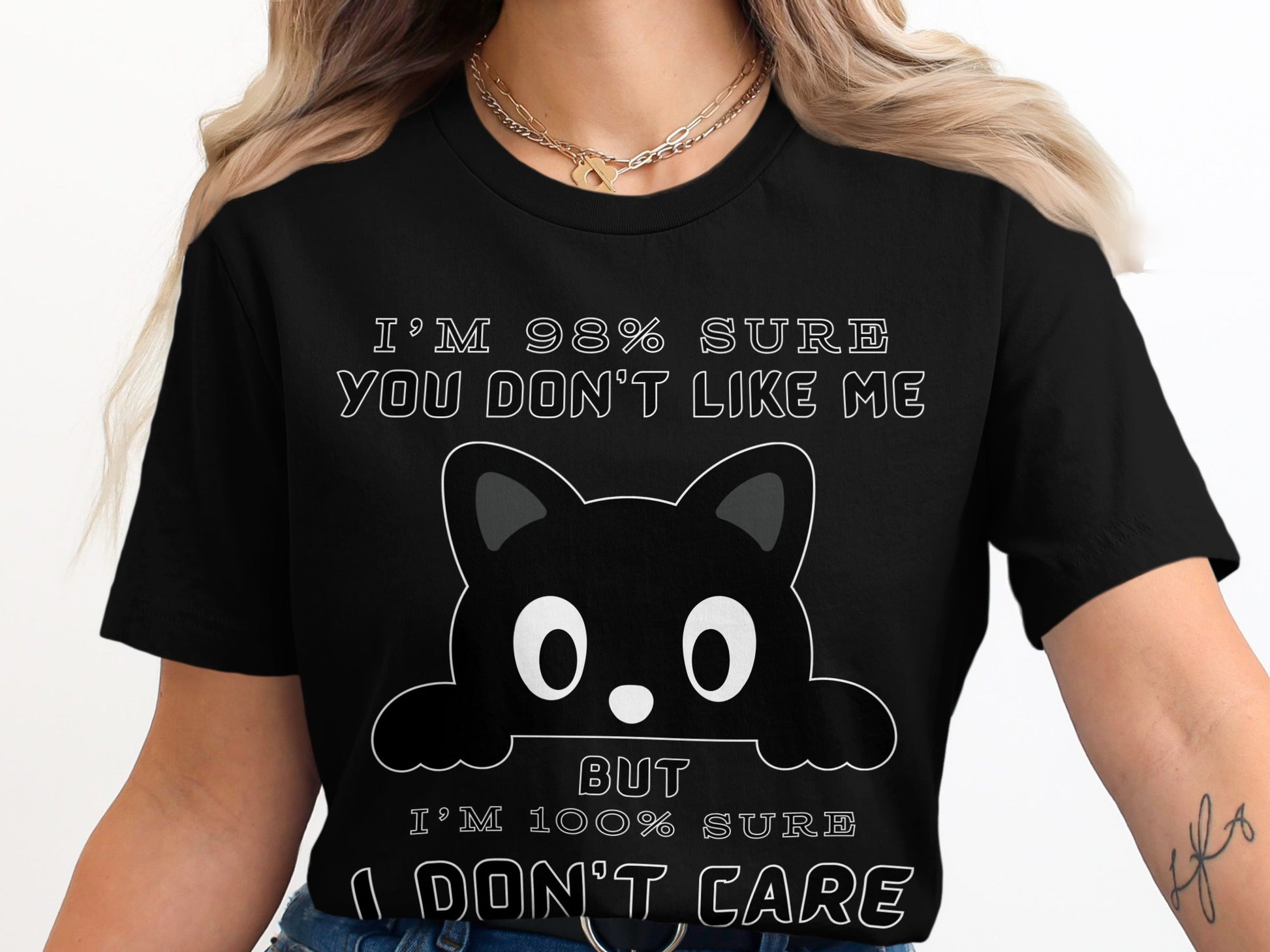 Black t-shirt with cartoon cat and text "I'm 98% sure you don't like me But I'm 100% sure I don't care".