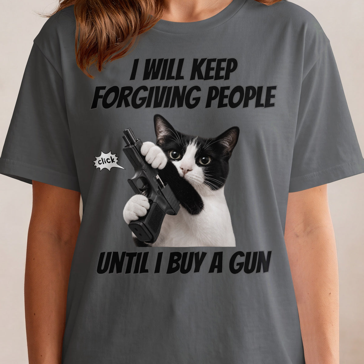 T-shirt with text "I will keep forgiving people until I buy a gun" and a cat holding a gun.