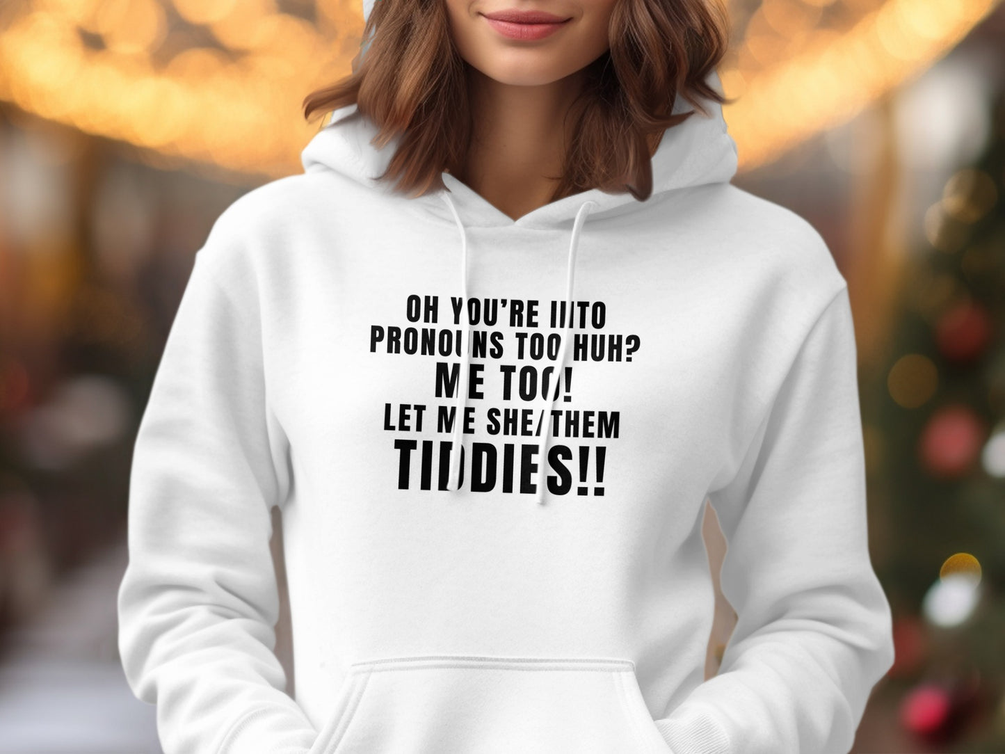 White hoodie with black text asking "Oh you're into pronouns too huh? Me too! Let me she/them tiddies!!"