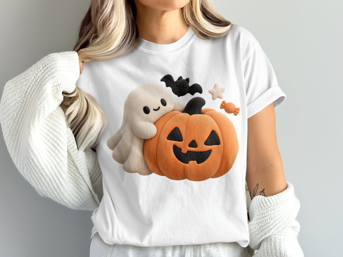 White t-shirt with a cute ghost, jack-o'-lantern, bat, and candy Halloween graphic.