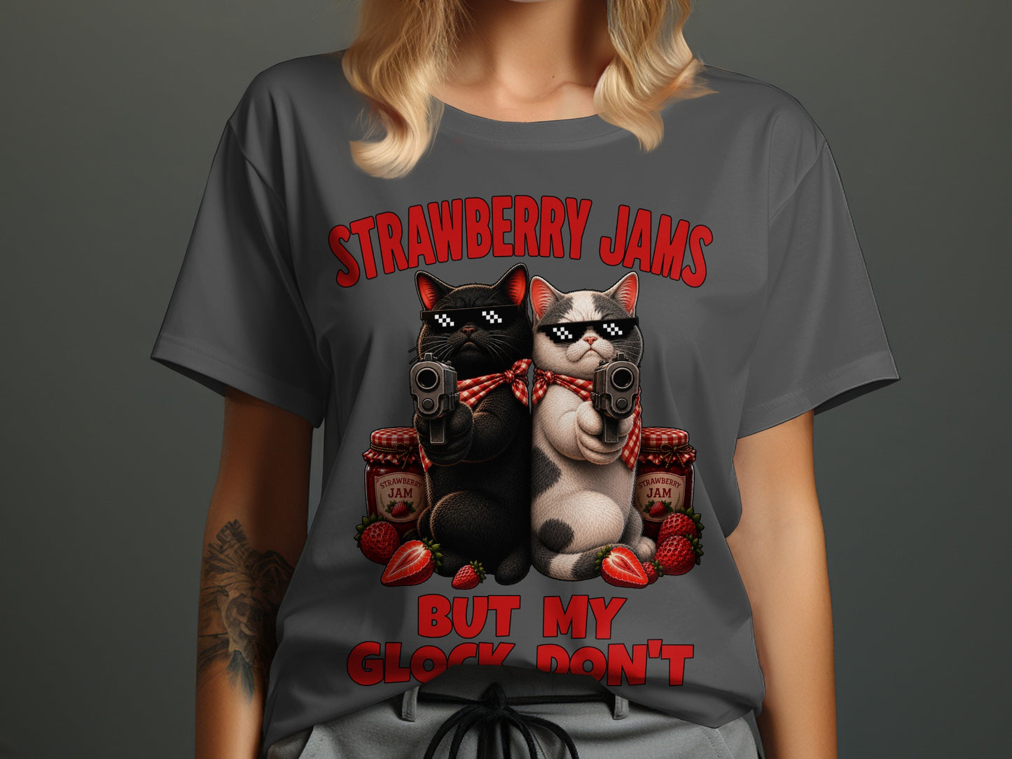 Two cats with sunglasses and guns beside jars of strawberry jam.