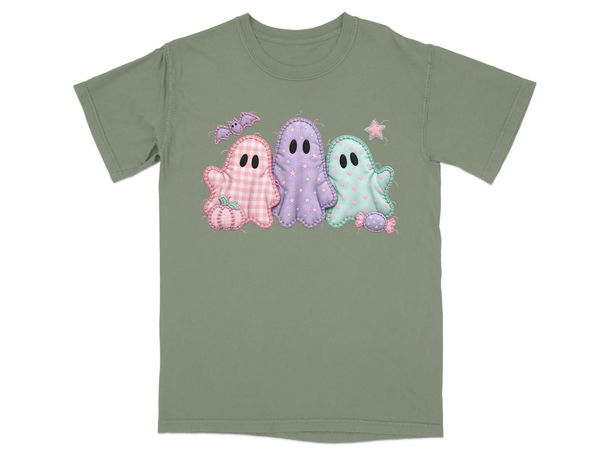 Green t-shirt with three pastel ghosts, bat, pumpkin, and candy applique design.