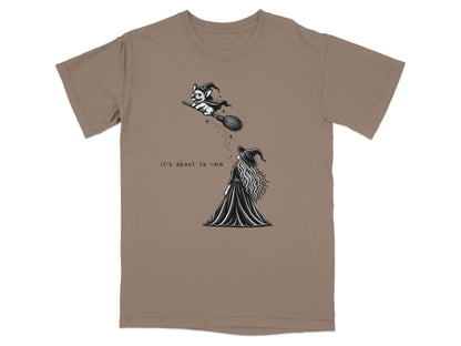French bulldog in witch hat flies on broom, text says "It's about to rain."