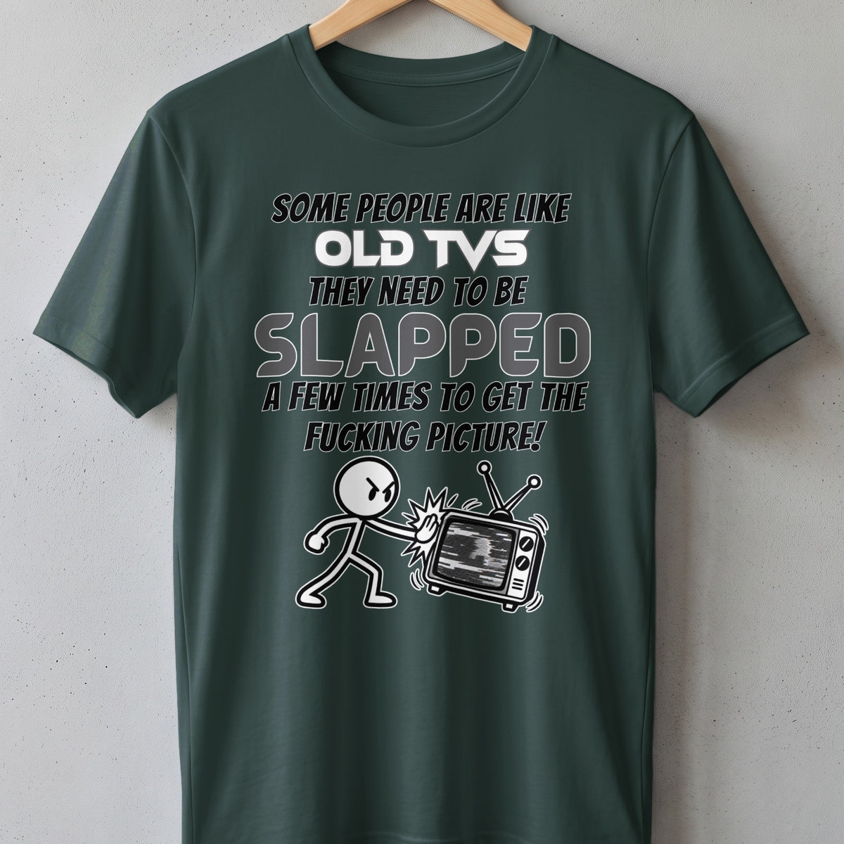 Dark green t-shirt with text about old TVs and a cartoon character hitting a TV.