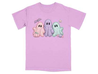 Three pastel ghosts with Halloween accents on a lavender t-shirt.