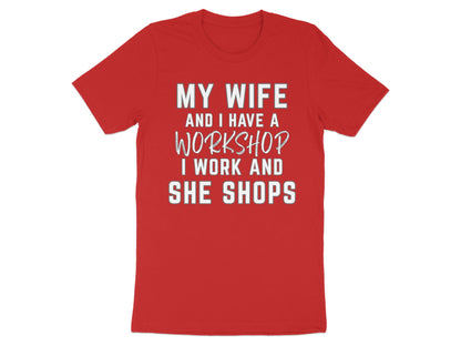 Red t-shirt with white text "MY WIFE AND I HAVE A WORKSHOP I WORK AND SHE SHOPS".